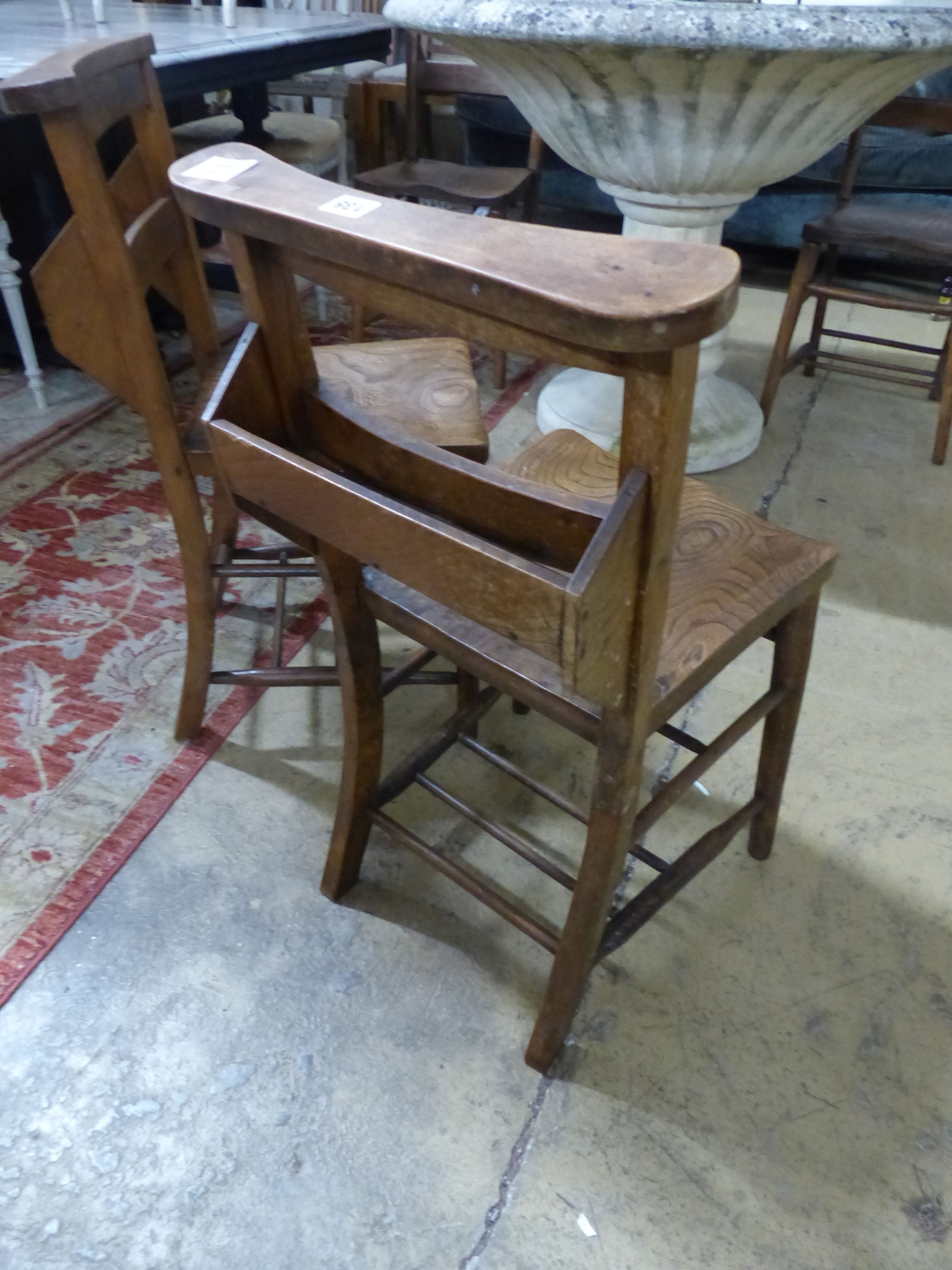 A set of four Victorian elm chapel chairs